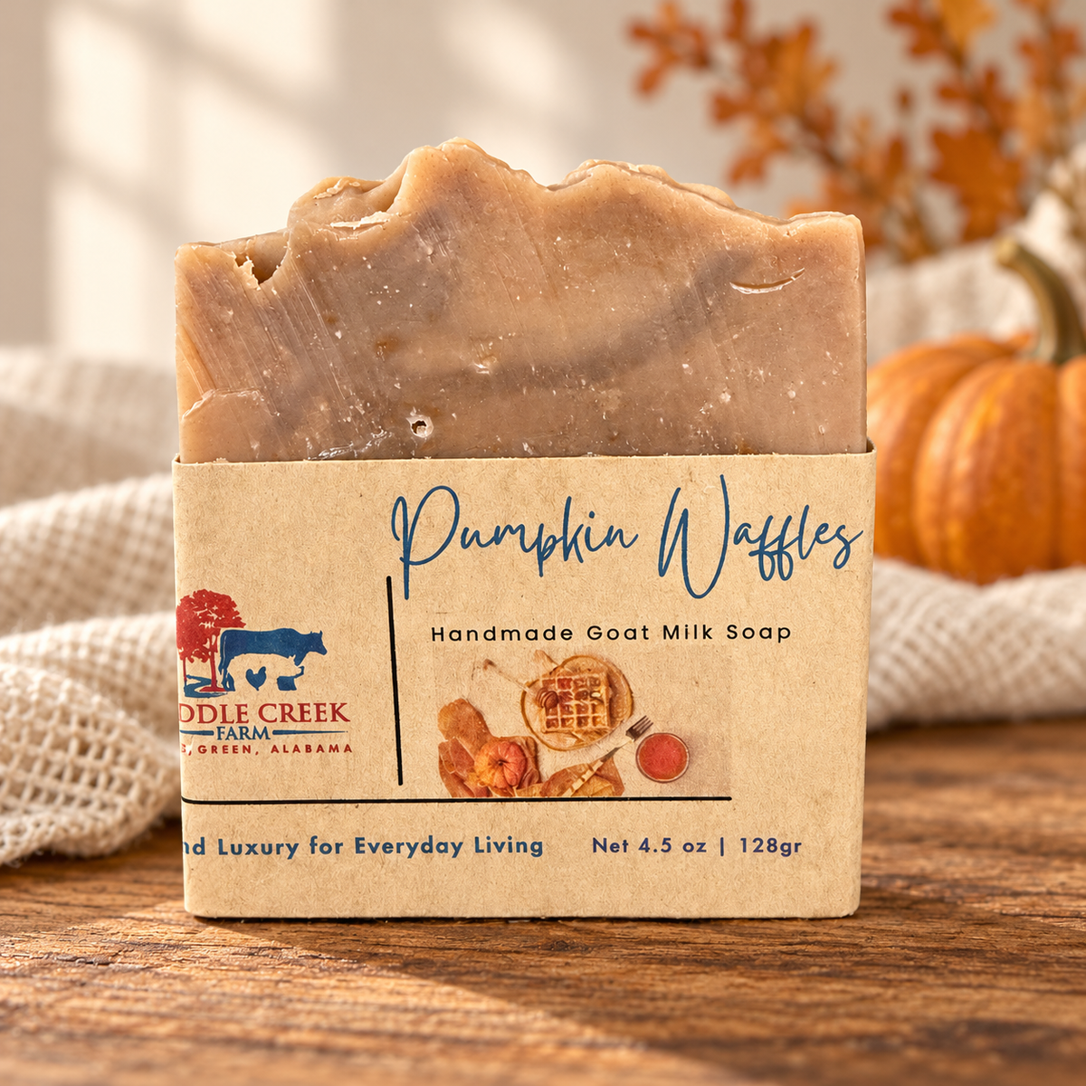 Middle Creek Farm Pumpkin Waffles goat milk soap on a wood surface with pumpkins and cream linen.
